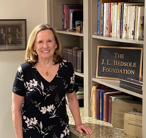 A woman standing in front of some books